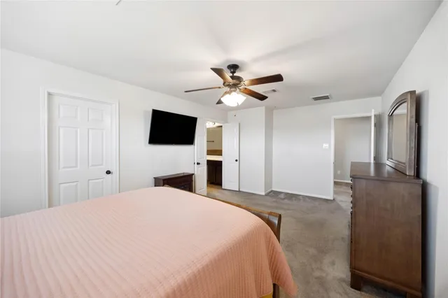 a view of a room with racks on the wall and a window