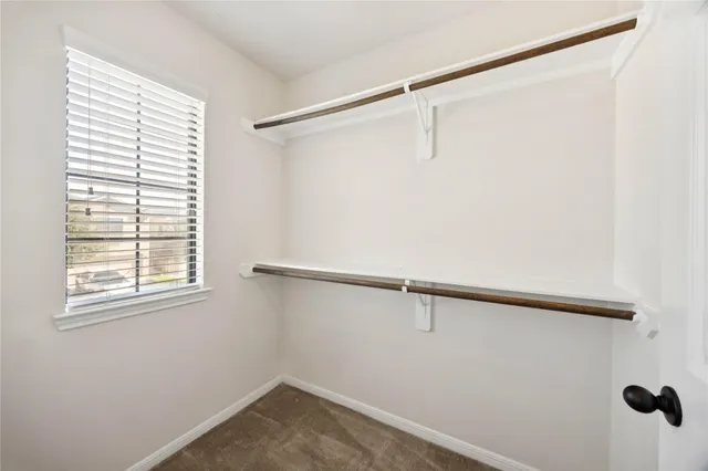 a spacious bathroom with a double vanity sink a mirror and a shower