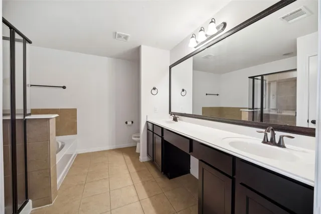 a bathroom with a tub and shower