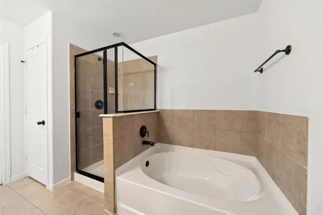 a spacious bathroom with a granite countertop sink mirror and shower