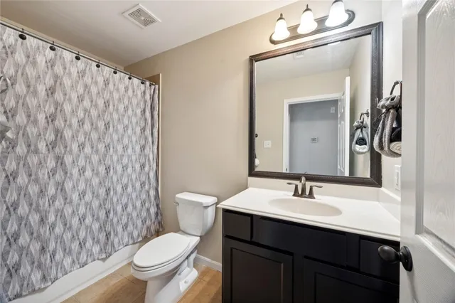 a view of a house with backyard and wooden fence