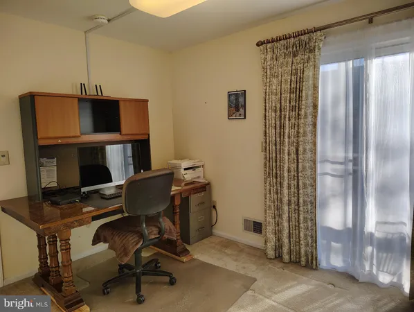 a view of a room with a window and a chair