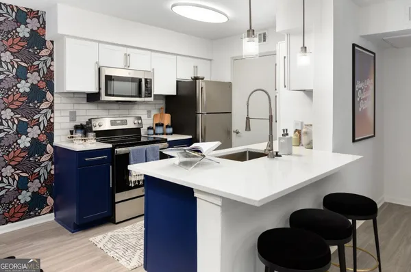 a kitchen with a sink cabinets and stainless steel appliances