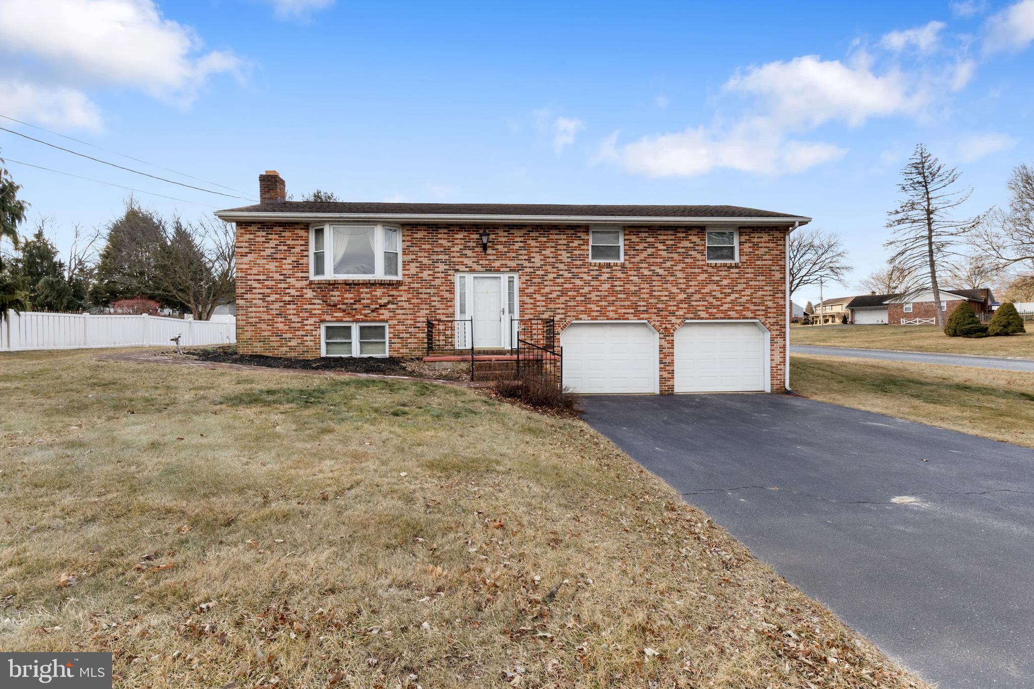 2266 Sycamore Road York, PA 17408 - Photo 1 of 43 a front view of a house with a yard and garage
