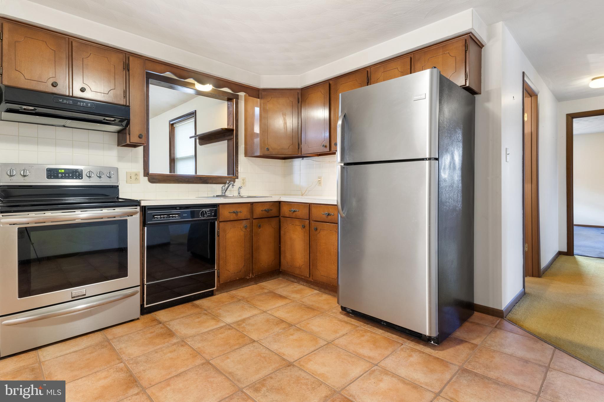 2266 Sycamore Road York, PA 17408 - Photo 14 of 43 a kitchen with stainless steel appliances granite countertop a refrigerator and a stove top oven