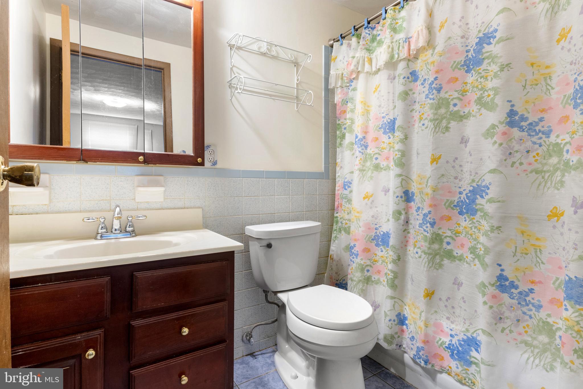 2266 Sycamore Road York, PA 17408 - Photo 20 of 43 a bathroom with a sink a toilet and shower curtain