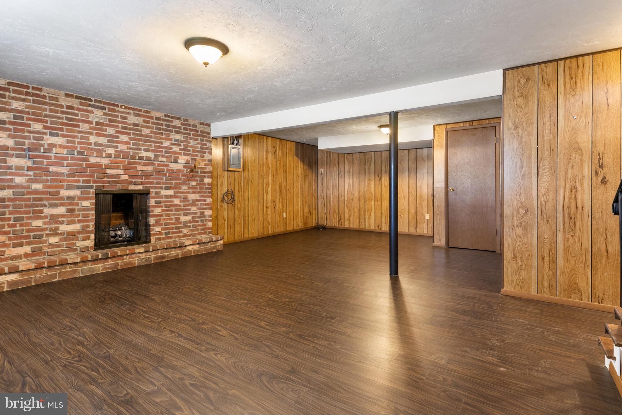 2266 Sycamore Road York, PA 17408 - Photo 27 of 43 an empty room with wooden floor and fireplace