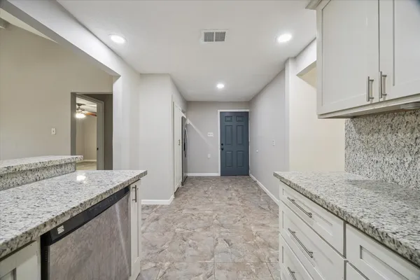a view of a kitchen with a sink and dishwasher a refrigerator freezer