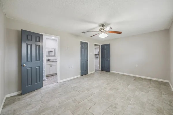 a bedroom with a bed and a desk