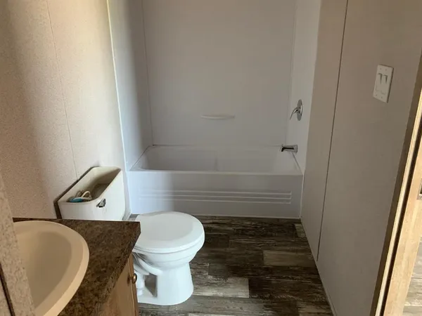 a bathroom with a toilet and a shower