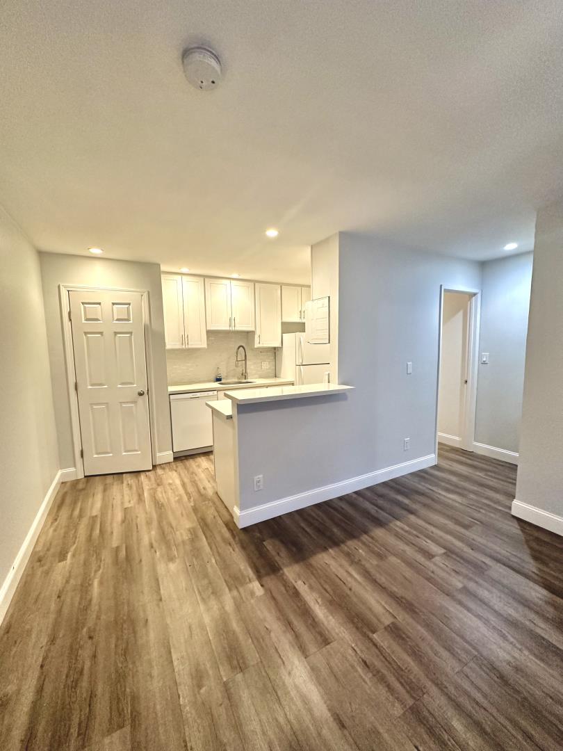 401 Piccadilly Place, Unit 9 San Bruno, CA 94066 - Photo 2 of 8 a view of a kitchen with wooden floor and a sink