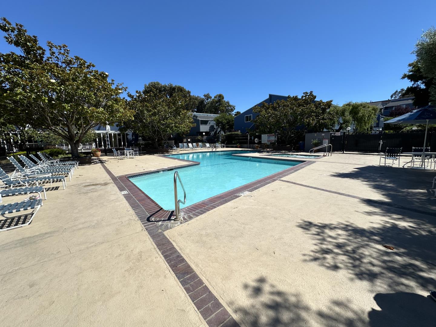 401 Piccadilly Place, Unit 9 San Bruno, CA 94066 - Photo 7 of 8 a view of swimming pool with lounge chair and dinning table under an umbrella