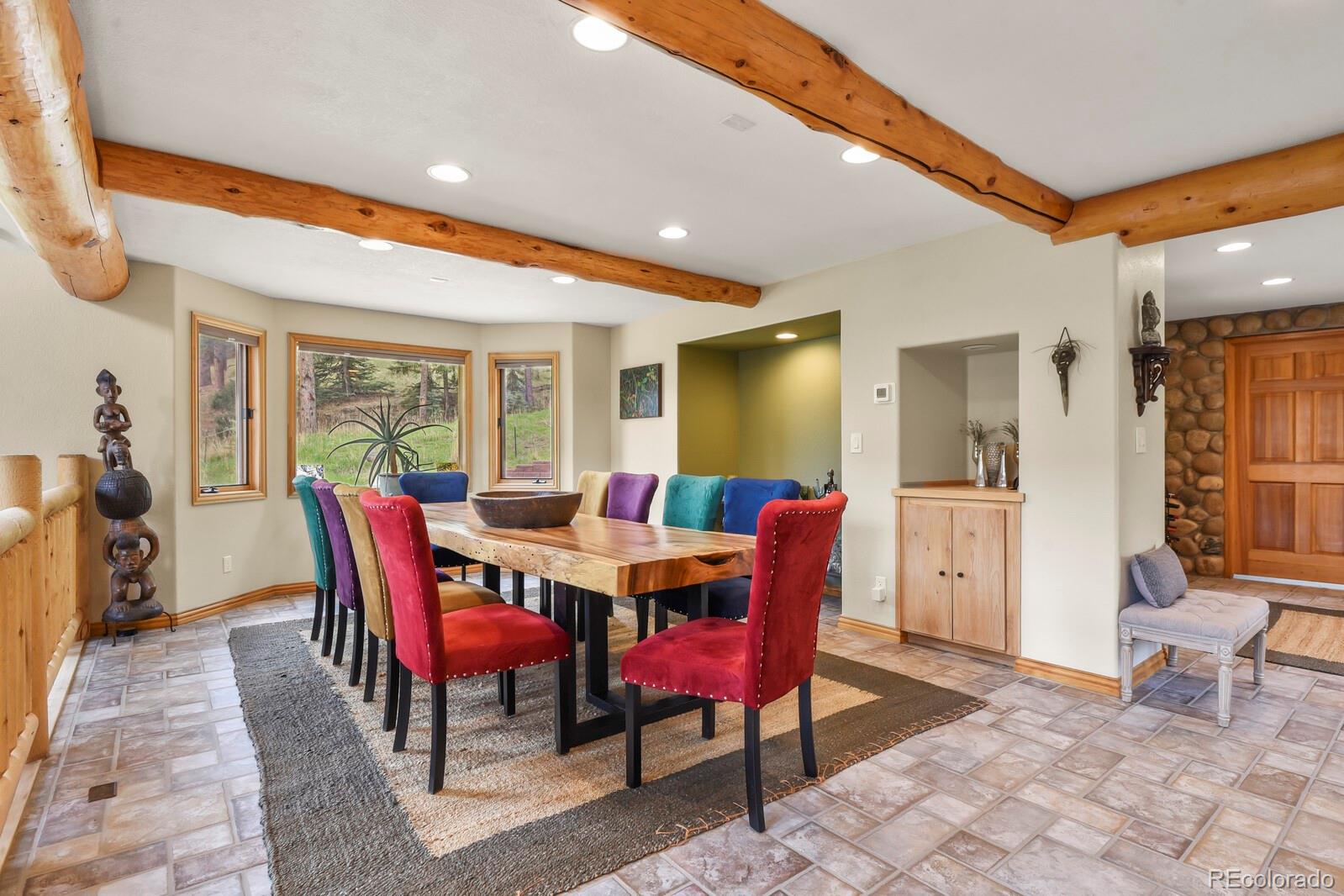 417 Witter Gulch Road Evergreen, CO 80439 - Photo 13 of 50 a view of a dining room with furniture