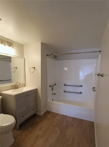 a bathroom with a double vanity sink toilet and shower