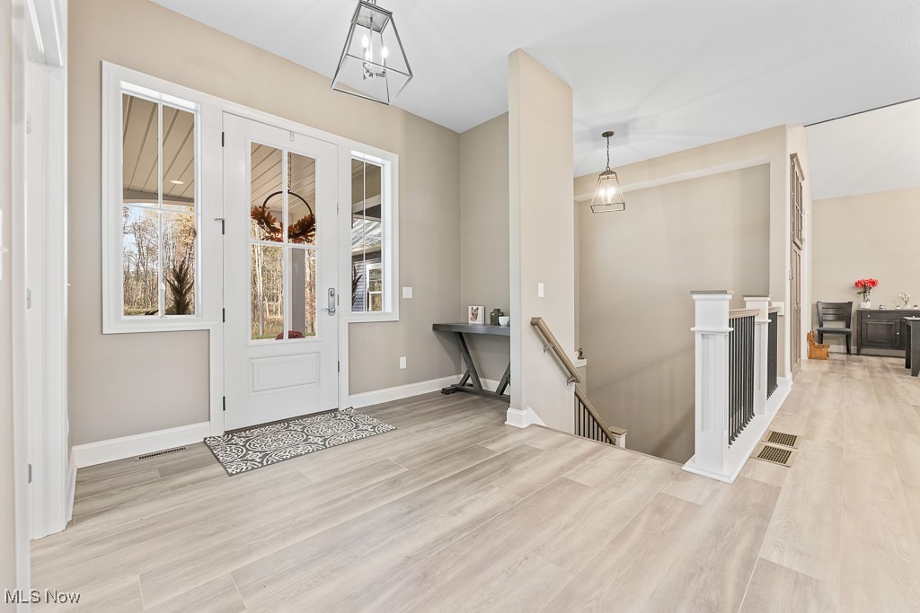 9340 Yale Road Diamond, OH 44412 - Photo 6 of 50 Entrance foyer featuring light luxury plank flooring and view to lower level