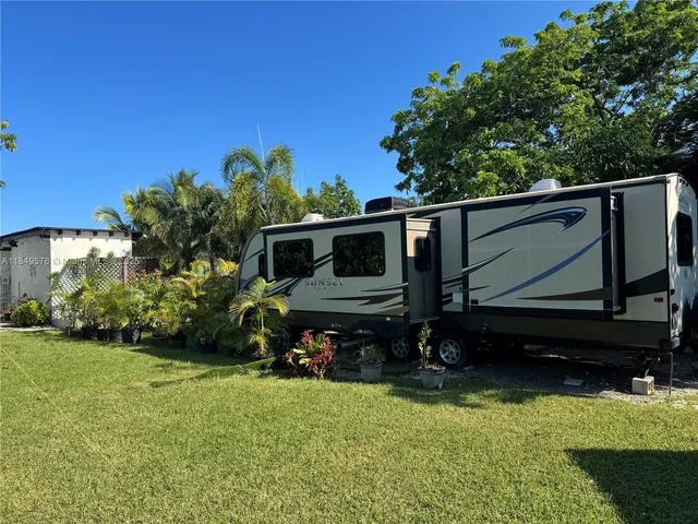 a view of a patio with table and chairs couches with wooden floor and fence