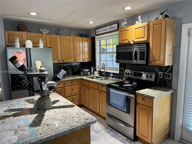 a living room with furniture a window and a flat screen tv