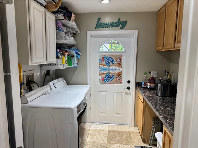 an aerial view of a house with swimming pool and outdoor seating