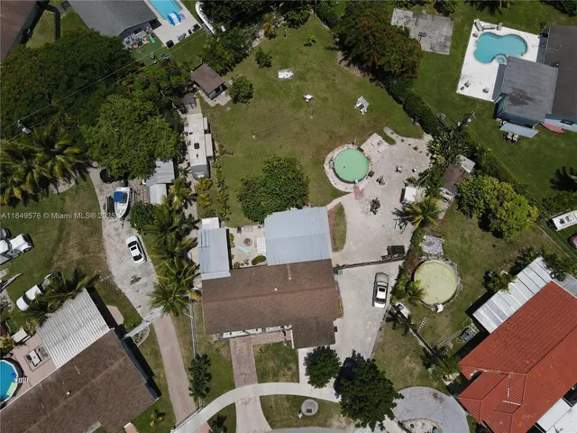 an aerial view of a house with large trees