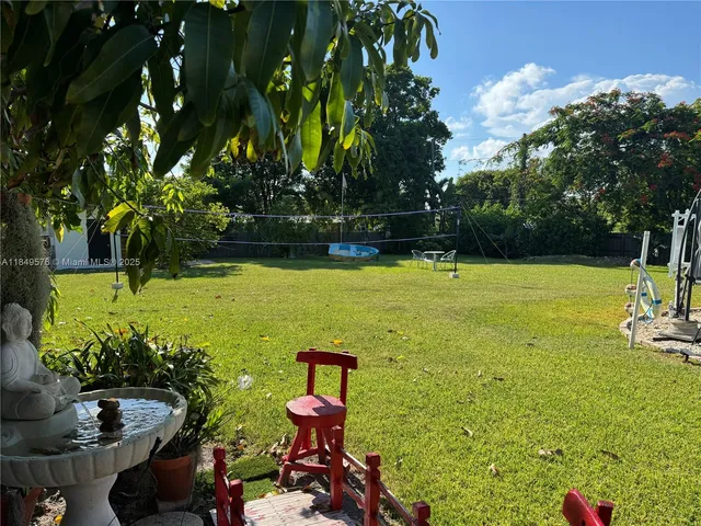 a view of a garden with lawn chairs