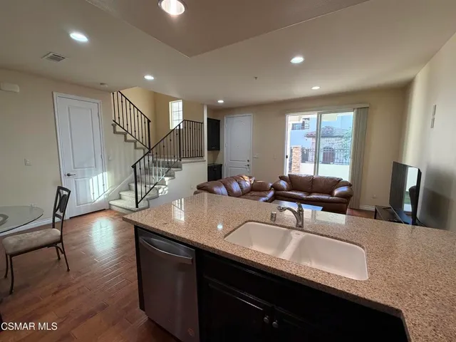 a kitchen with sink granite counter top space and furniture