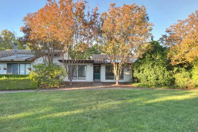 a front view of a house with a garden