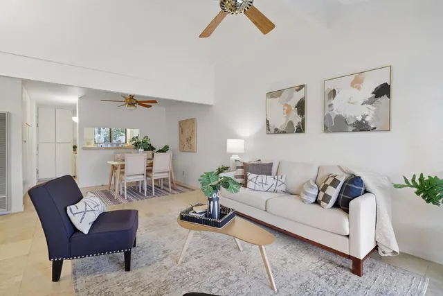 a dining room with furniture potted plants and wooden floor