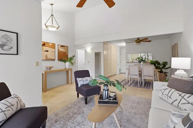 a view of a kitchen with refrigerator and white cabinets