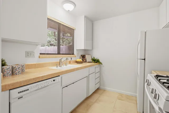a bathroom with a tub sink and a window