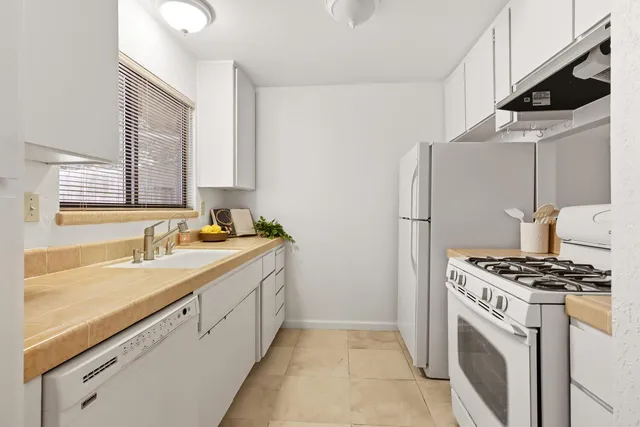 a bedroom with a bed and a potted plant