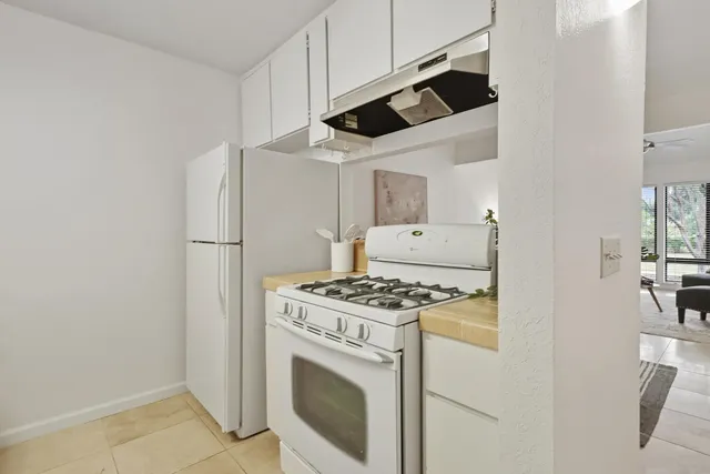 a bathroom with a granite countertop sink a toilet and a mirror