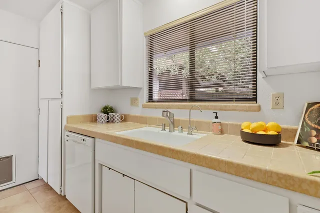 a kitchen with a refrigerator and a sink