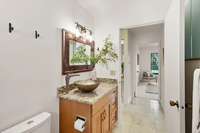 a view of a house with a tree and plants