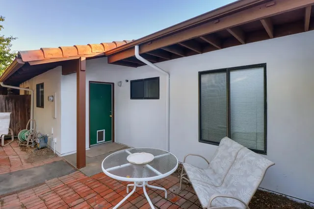 a balcony with table and chairs