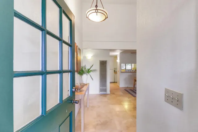 a view of entryway with a window and wooden floor
