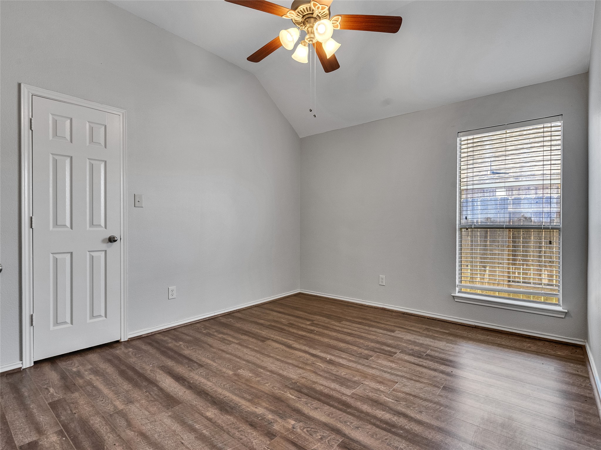5643 Walnut Glen Lane Rosenberg, TX 77471 - Photo 33 of 42 an empty room with wooden floor chandelier fan and windows