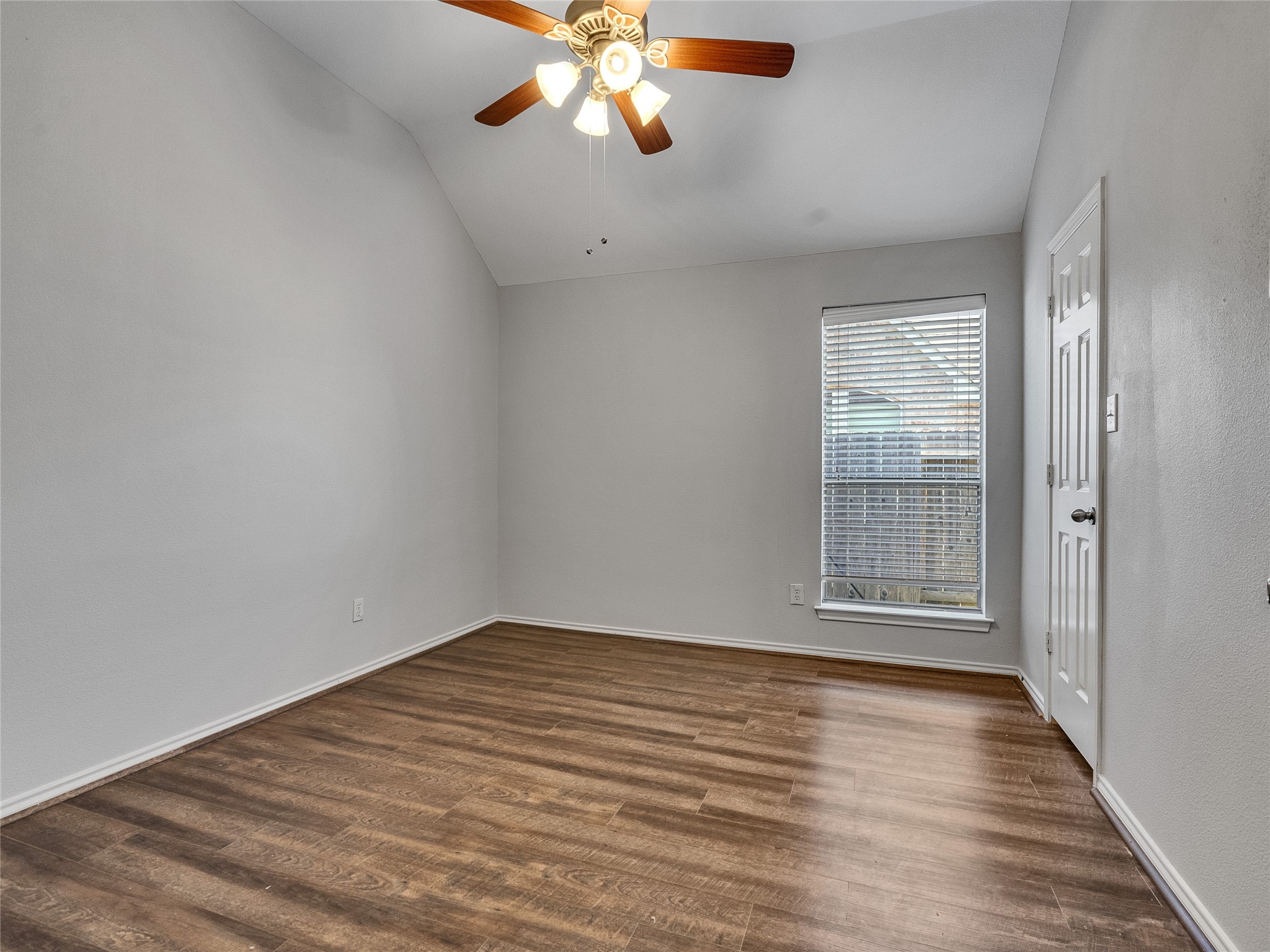 5643 Walnut Glen Lane Rosenberg, TX 77471 - Photo 37 of 42 a view of an empty room with wooden floor and a window