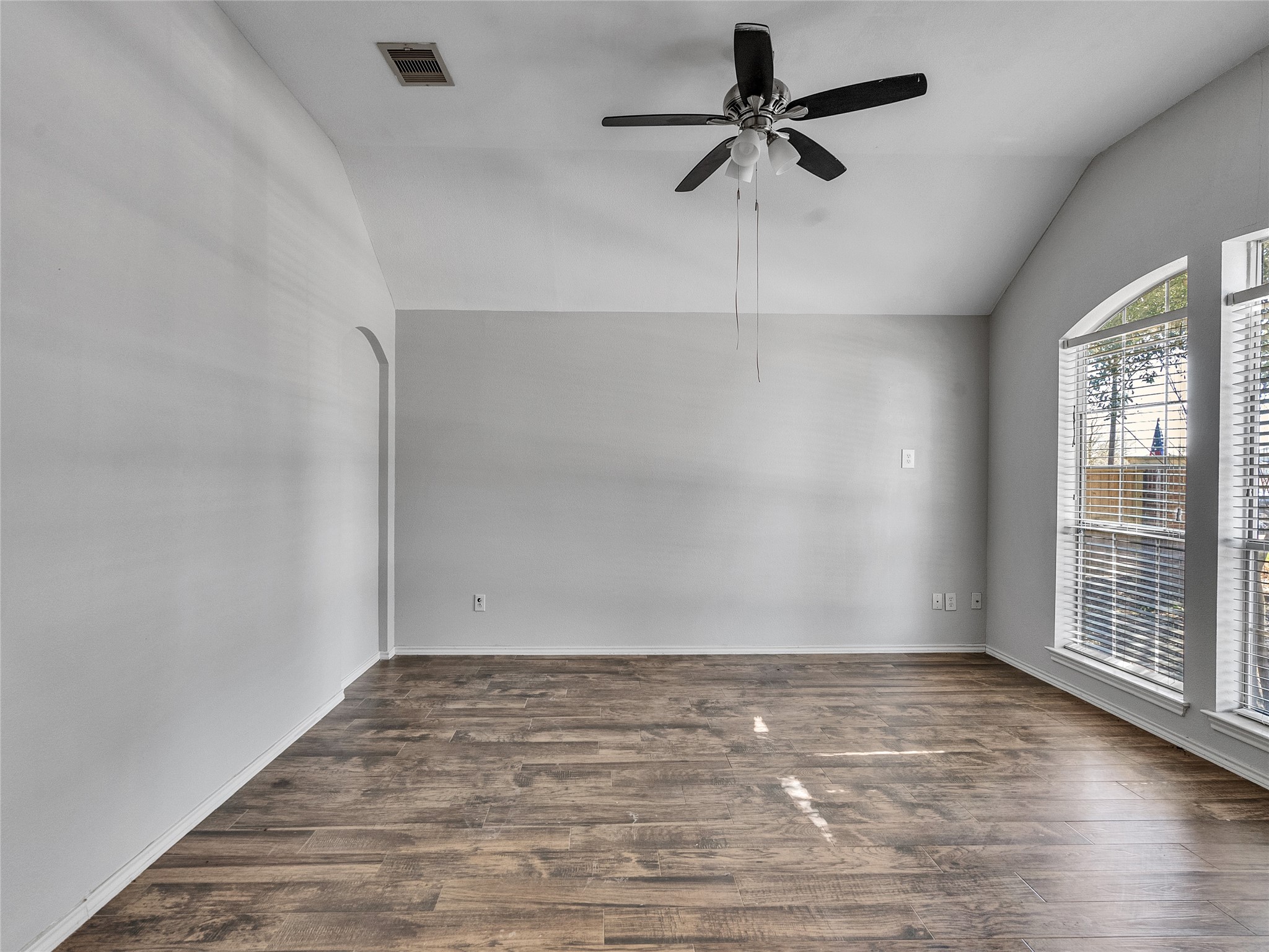 5643 Walnut Glen Lane Rosenberg, TX 77471 - Photo 41 of 42 an empty room with wooden floor fan and windows
