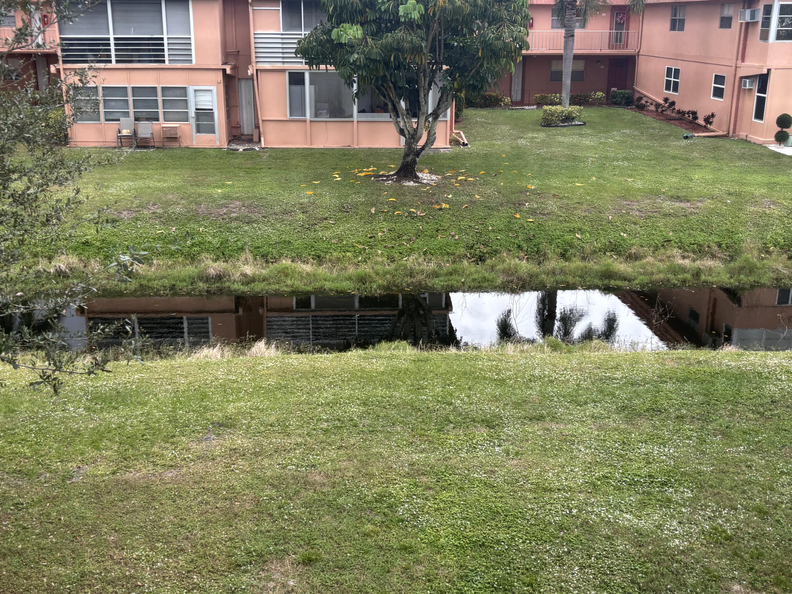 596 Saxony M, Unit 596 Delray Beach, FL 33446 - Photo 1 of 23 a backyard of a house with lots of green space