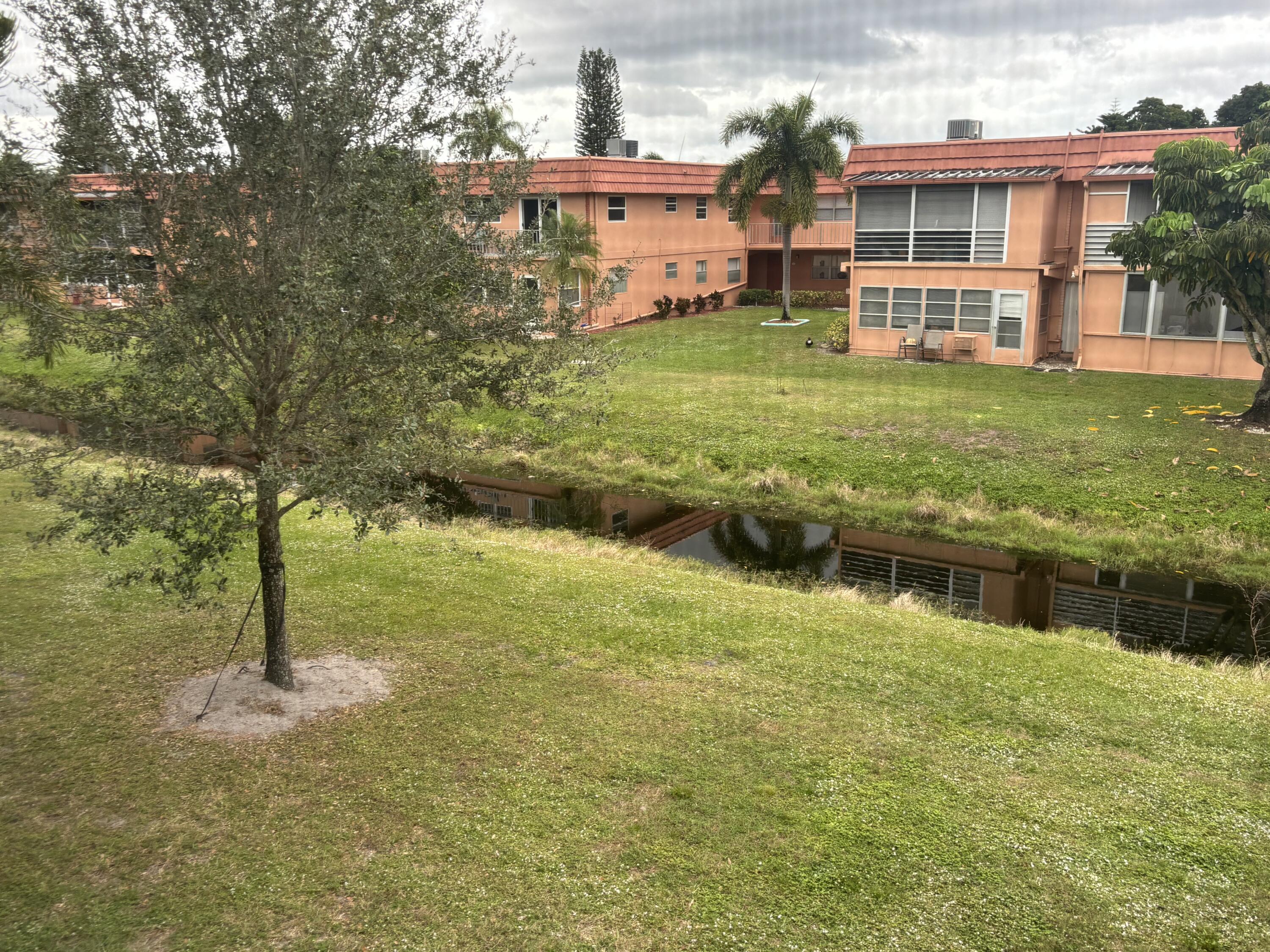 596 Saxony M, Unit 596 Delray Beach, FL 33446 - Photo 15 of 23 a view of a house with a yard