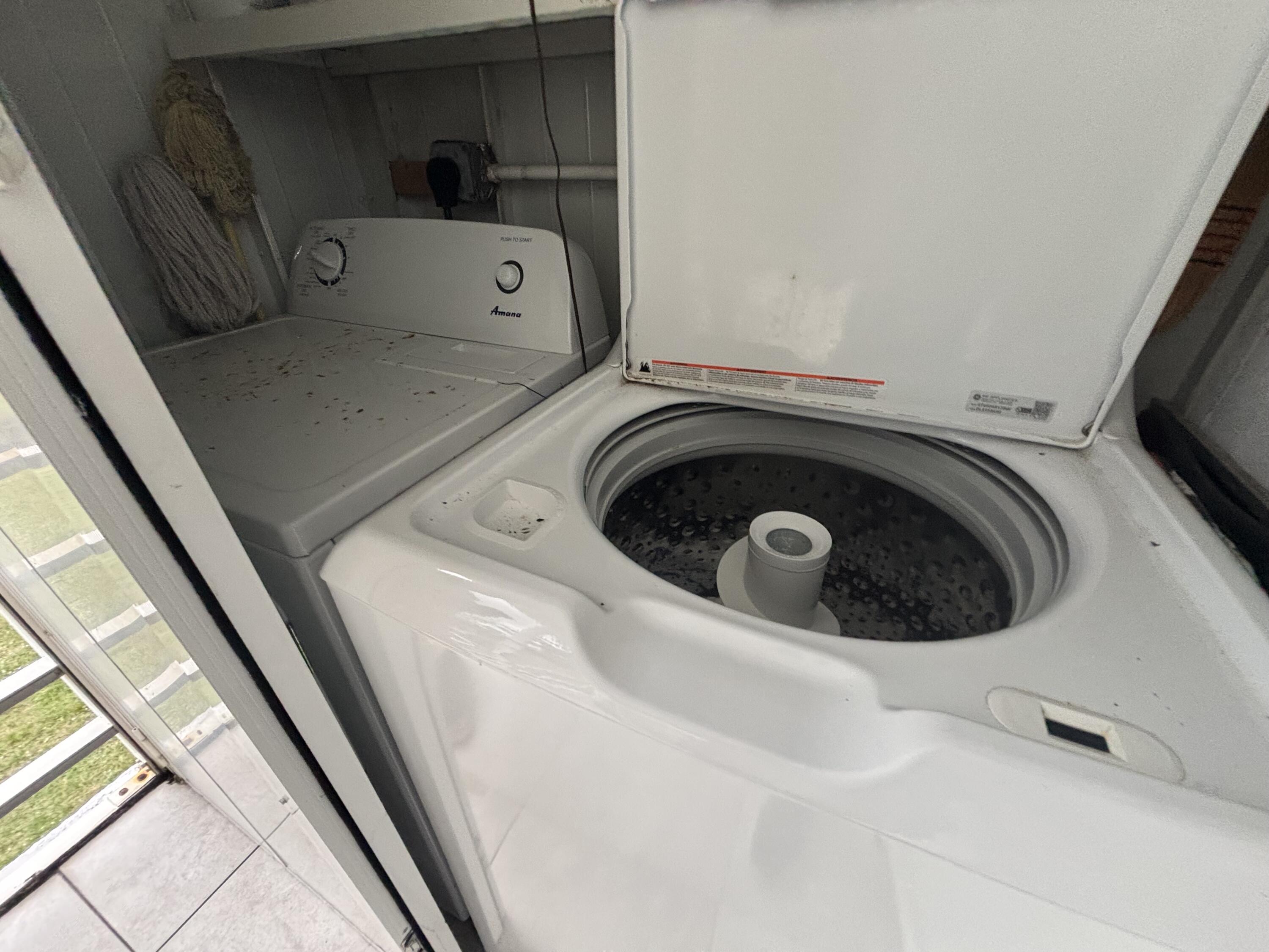 596 Saxony M, Unit 596 Delray Beach, FL 33446 - Photo 18 of 23 a utility room with a washer and dryer