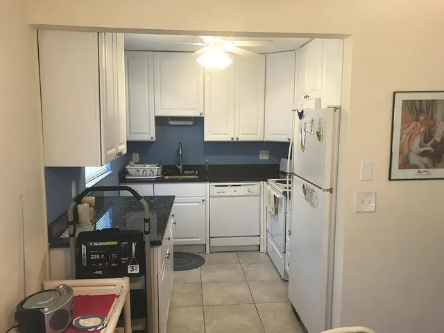 a kitchen with a refrigerator and a stove