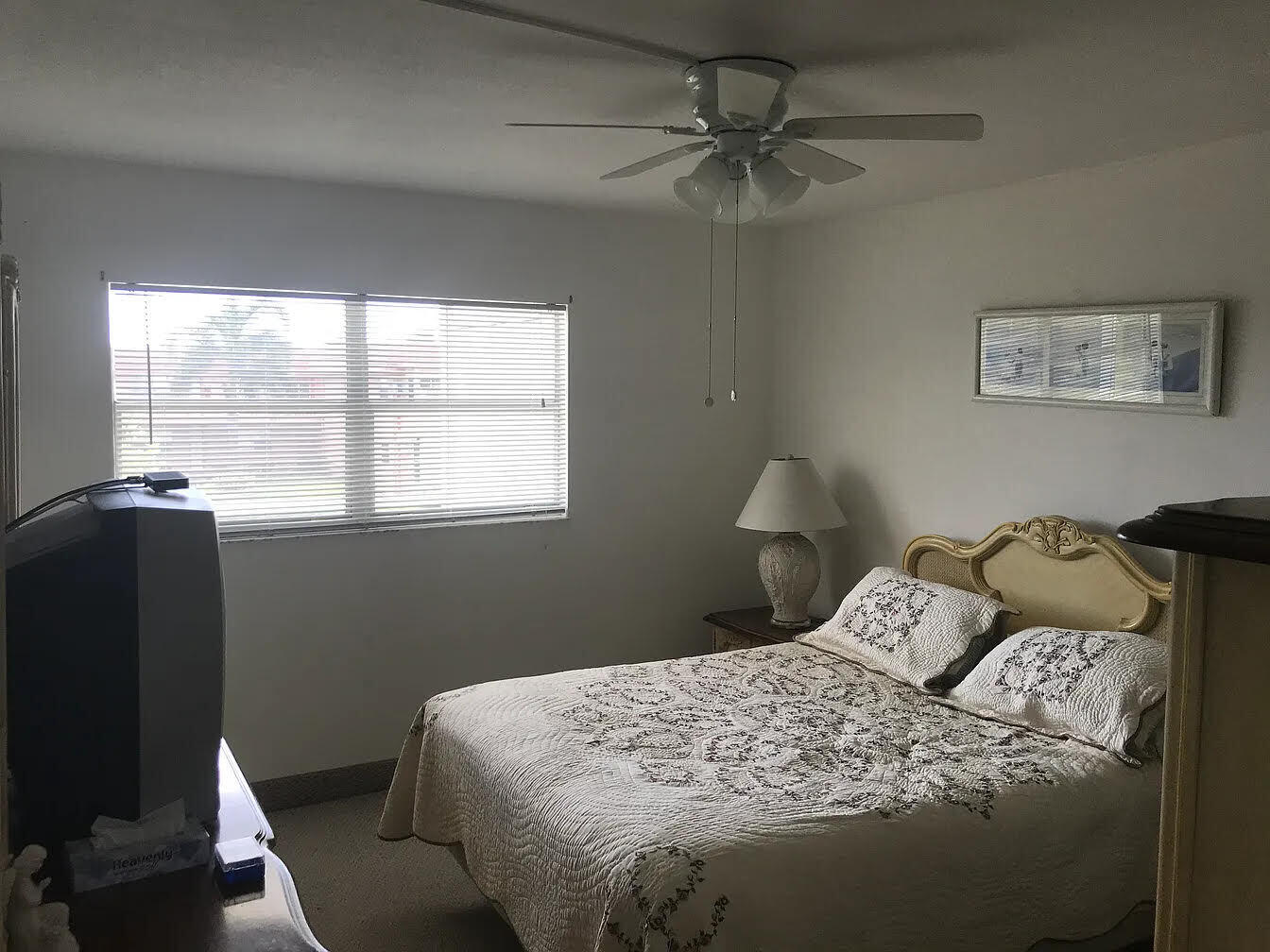 596 Saxony M, Unit 596 Delray Beach, FL 33446 - Photo 5 of 23 a bedroom with a bed and a window