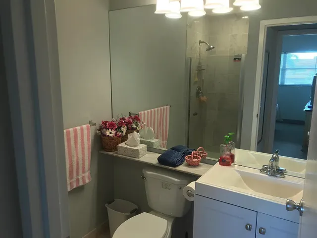 a bathroom with a sink toilet and shower