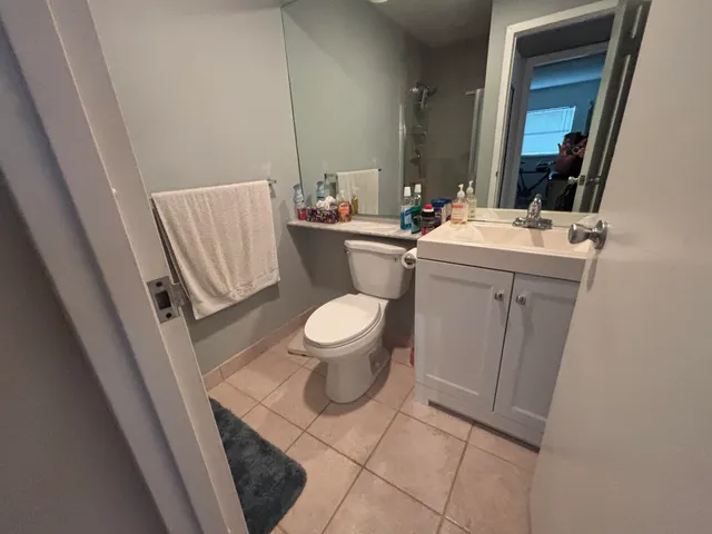 a bathroom with a toilet sink and mirror