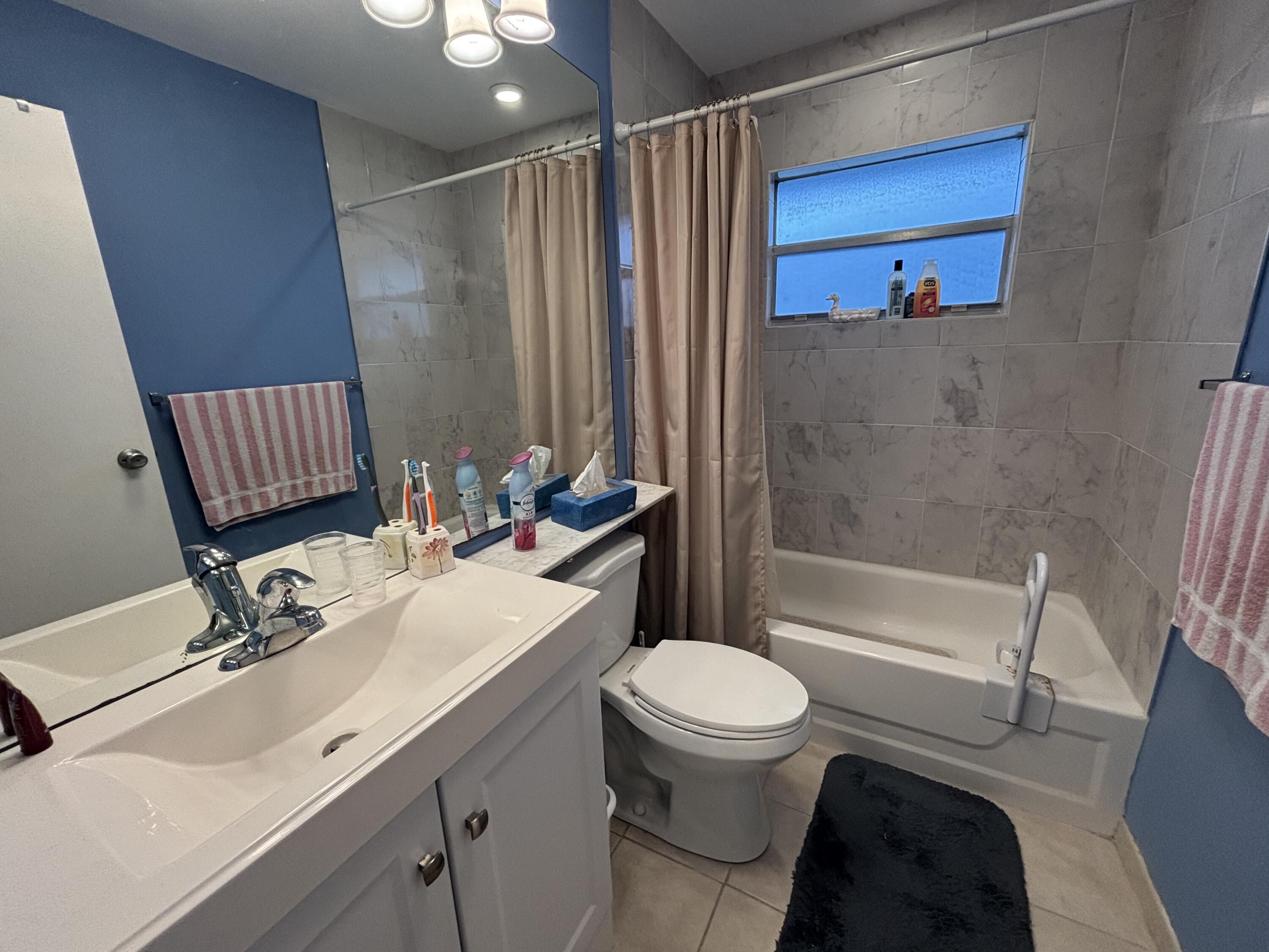 596 Saxony M, Unit 596 Delray Beach, FL 33446 - Photo 9 of 23 a bathroom with a sink toilet and shower