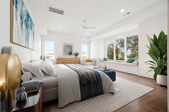 a bedroom with a large bed and a potted plant