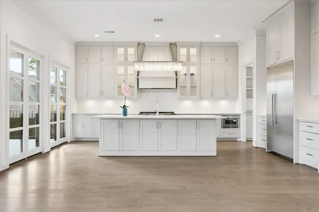 a view of kitchen with stainless steel appliances granite countertop a stove a sink and a refrigerator