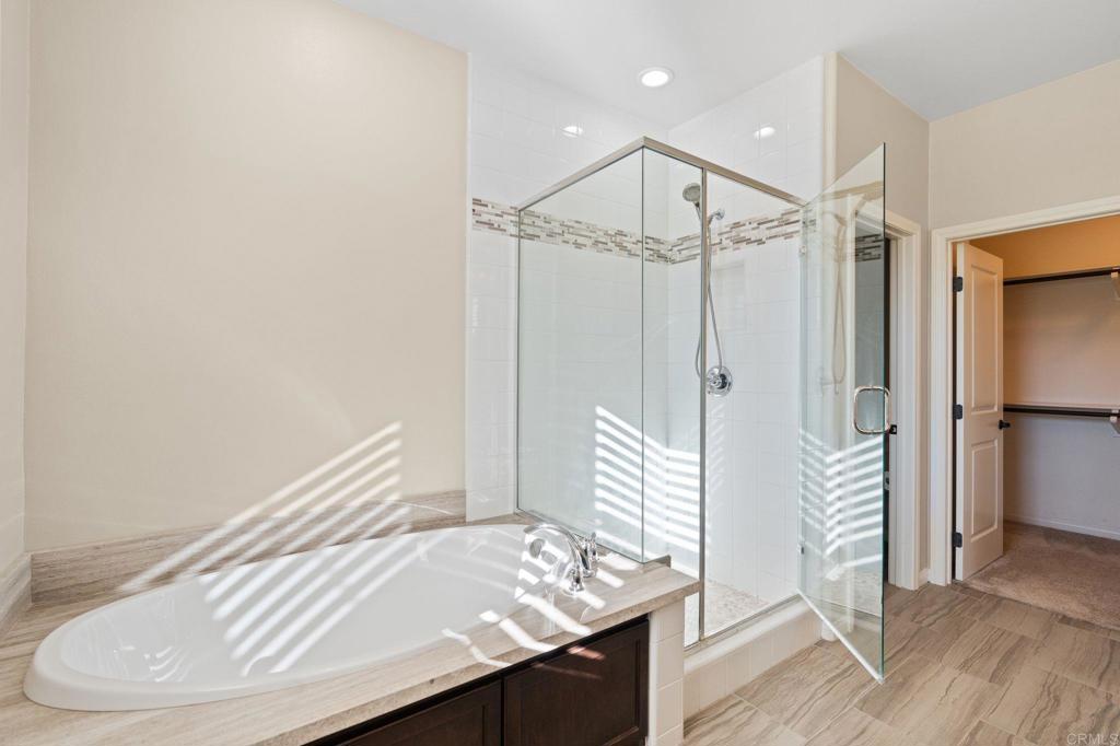 15968 Parkview Loop San Diego, CA 92127 - Photo 14 of 45 a bathroom with a bathtub and a shower