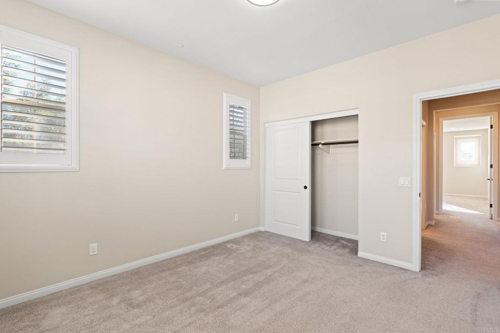 15968 Parkview Loop San Diego, CA 92127 - Photo 17 of 45 an empty room with windows and closet